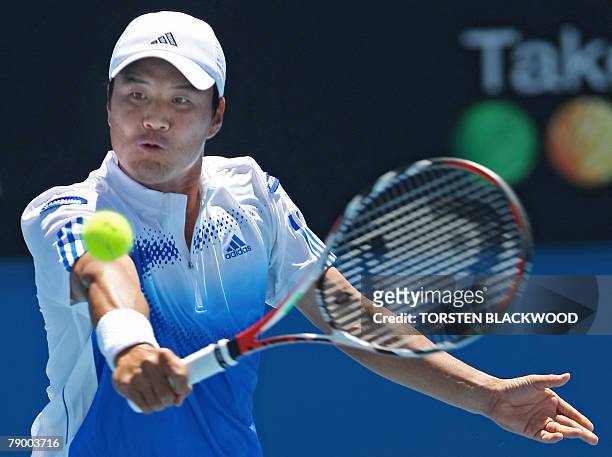 South Korean tennis player Lee Hyung-Taik plays a return during his mens singles match against Australian opponent Chris Guccione at the Australian...