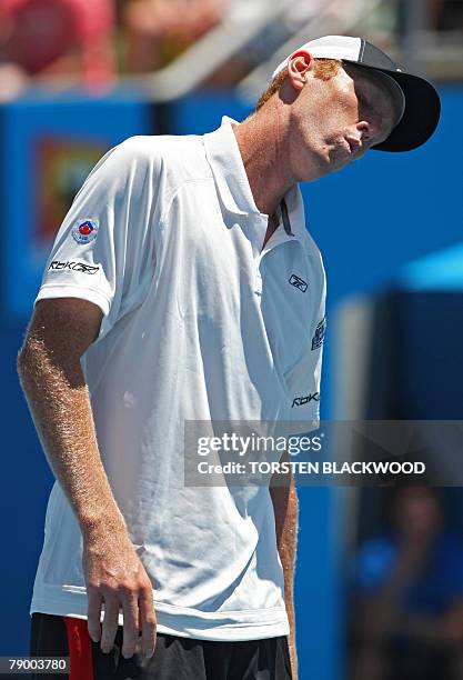 Australian tennis player Chris Guccione reacts during his mens singles match against South Korean Lee Hyung-Taik at the Australian Open tennis...