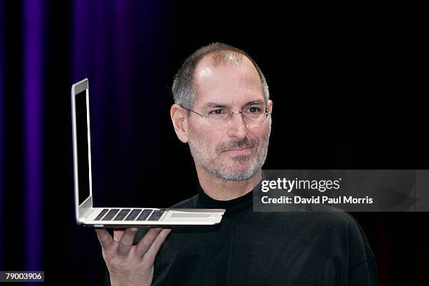 Apple CEO and co-founder Steve Jobs holds up the new Mac Book Air after he delivered the keynote speech to kick off the 2008 Macworld at the Moscone...