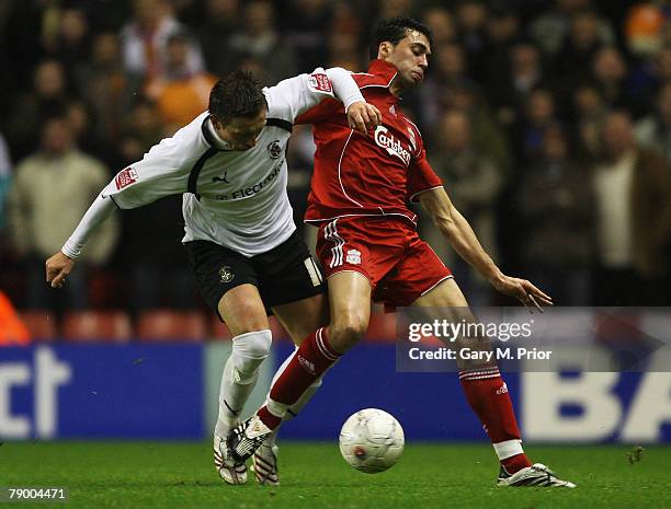 Alvaro Arbeloa of Liverpool and Darren Currie of Luton battle for the ball during the FA Cup 3rd round replay sponsored by E.ON match between...