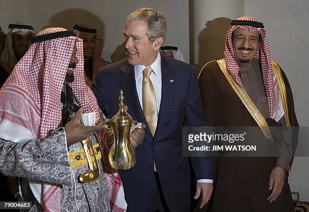 President George W. Bush and Prince Salman bin Abdul Aziz , the brother of the Saudi king and Governor of Riyadh, share a laugh with a man serving...