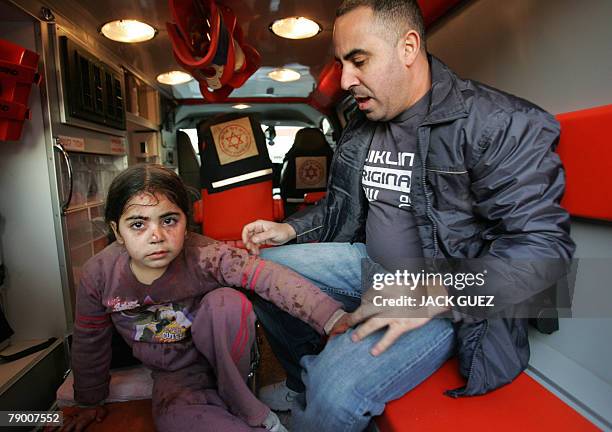 Magen David Adom nurse gives medical attention to an Israeli child injured after a rocket fired from the Gaza Strip struck her home in the southern...