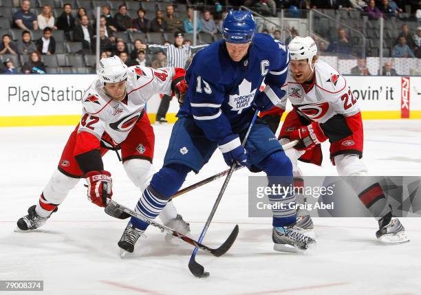 Mats Sundin of the Toronto Maple Leafs battles for the puck with Tim Gleason and Mike Commodore of the Carolina Hurricanes January 15, 2008 at the...