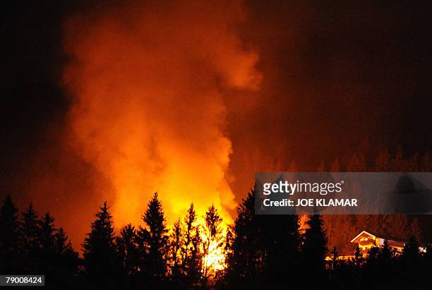 House burns in the Tirolian village of Kirchberg, near the famous Austrian resort of Kitzbuehel , 15 January, 2008. Dozens of fire trucks and their...