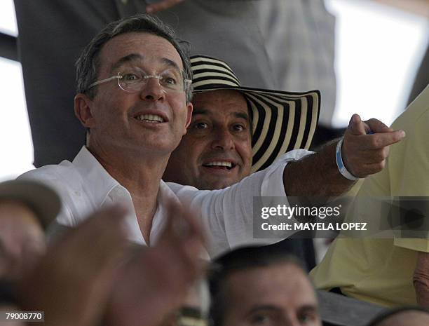 Colombian president, Alvaro Uribe , and PANACA president, Jorge Ballen , admire an equestrian exhibition at the opening ceremony of the National Park...