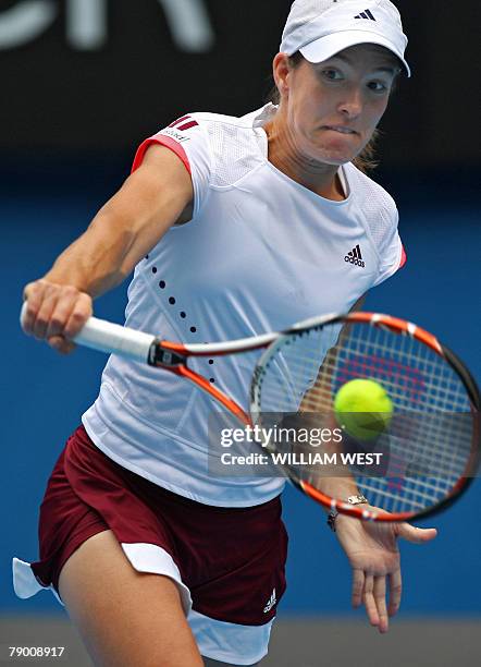 Belgian tennis player Justine Henin plays a return during her womens singles match against Russian opponent Olga Poutchkova at the Australian Open...