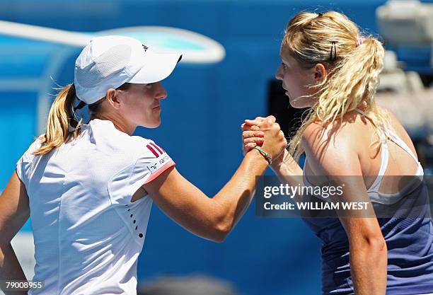Belgian tennis player Justine Henin shakes hands with Russian opponent Olga Poutchkova after their womens singles match at the Australian Open tennis...