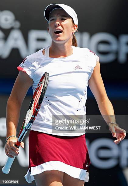 Belgian tennis player Justine Henin gestures during her womens singles match against Russian opponent Olga Poutchkova at the Australian Open tennis...
