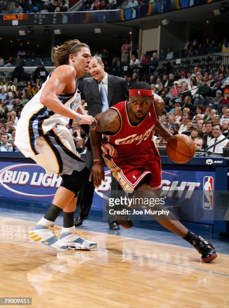 LeBron James of the Cleveland Cavaliers drives around Mike Miller of the Memphis Grizzlies on January 15, 2008 at the FedExForum in Memphis,...