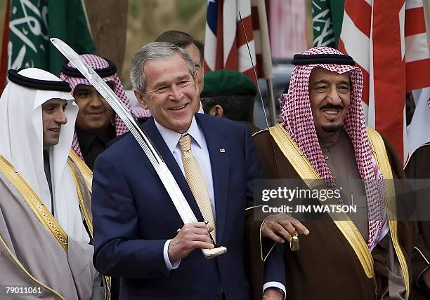 President George W. Bush dances with a sword with Prince Salman bin Abdul Aziz , the brother of the Saudi king and Governor of Riyadh, during their...