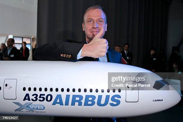 Airbus CEO Tom Enders poses in front of a A350 model as Airbus chiefs announce annual results during a press conference at the Airbus factory on...