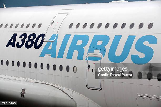 An Airbus A380 is seen as Airbus CEO Tom Enders, Tom Williams Fabrice Bregier and Tom Leahy announce results during a press conference in the...