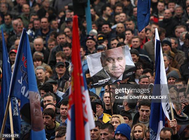 Kosovo Serbs hold a picture of presidential candidate and acting leader of the ultranationalist Serbian Radical Party Tomislav Nikolic during a...