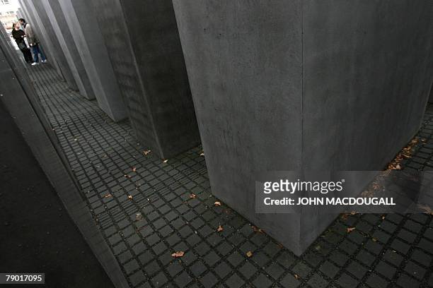 Couple stands in the Memorial for the Murdered Jews of Europe that was openen in 2005 and designed by US architect Peter Eisenmann 16 January 2008 in...