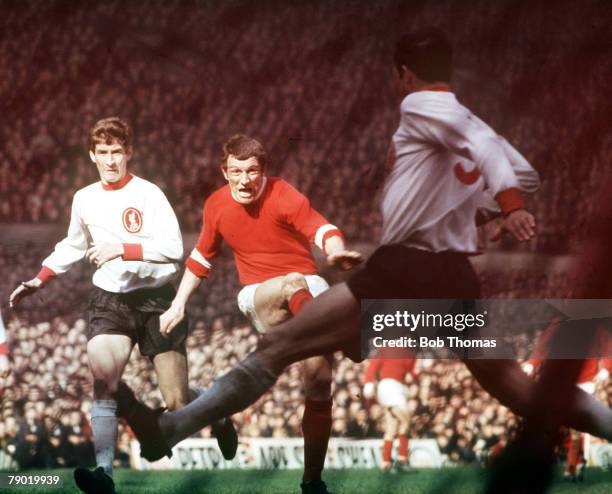 Football, 1960's, Manchester United's David Herd has his shot blocked by Liverpool defender Ron Yeats during their match