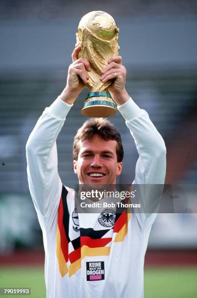 World Cup, Italy, West German captain Lothar Matthaus holds aloft the trophy at a photocall following their victory over Argentina in Rome