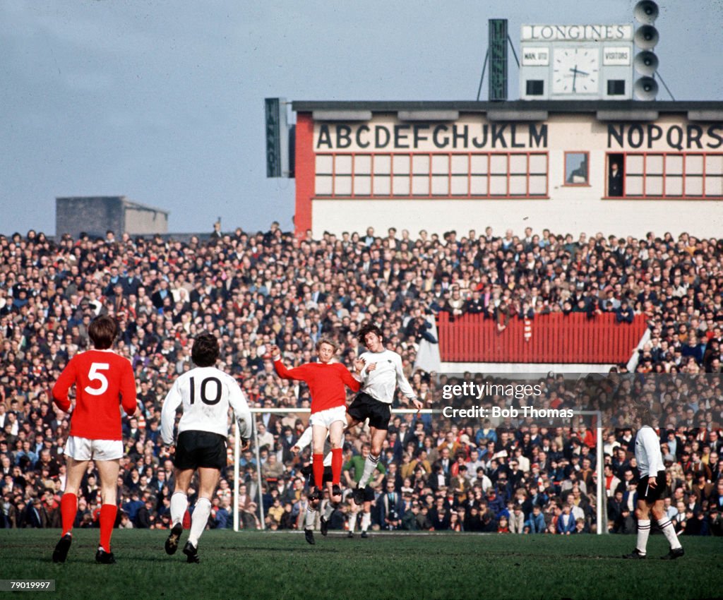 Football. 1971. Manchester United's Denis Law jumps up for the ball with Derby County's Roy McFarland during their league match at Old Trafford.