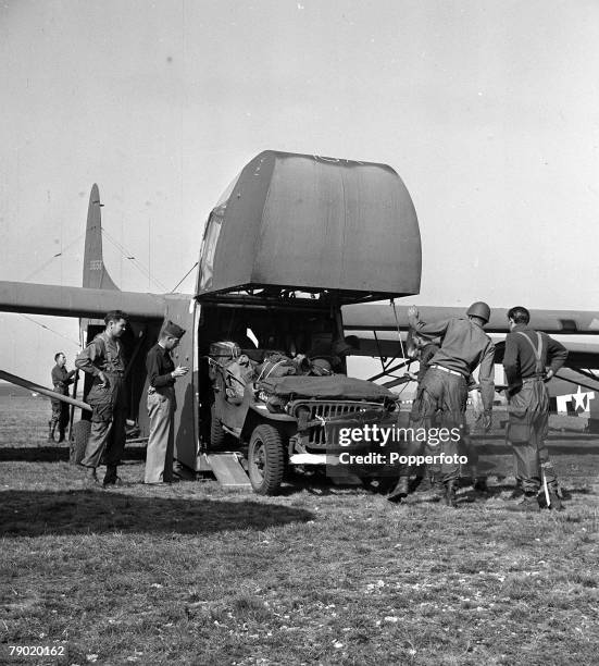 World War II England, Airborne troops load a Willys MB jeep into a USAAF Waco CG-4 assault glider for an invasion into Holland as part of Operation...