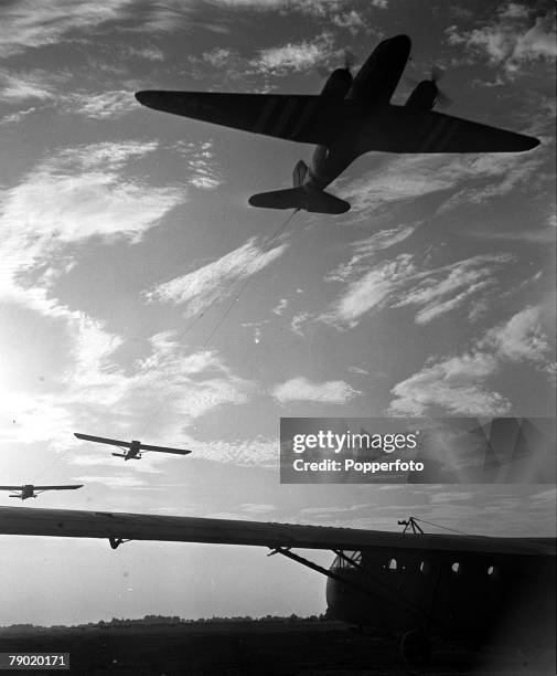 World War II England, Aircraft towing up Waco CG-4 gliders full of troops and equipment for an air invasion in Holland as part of Operation Market...