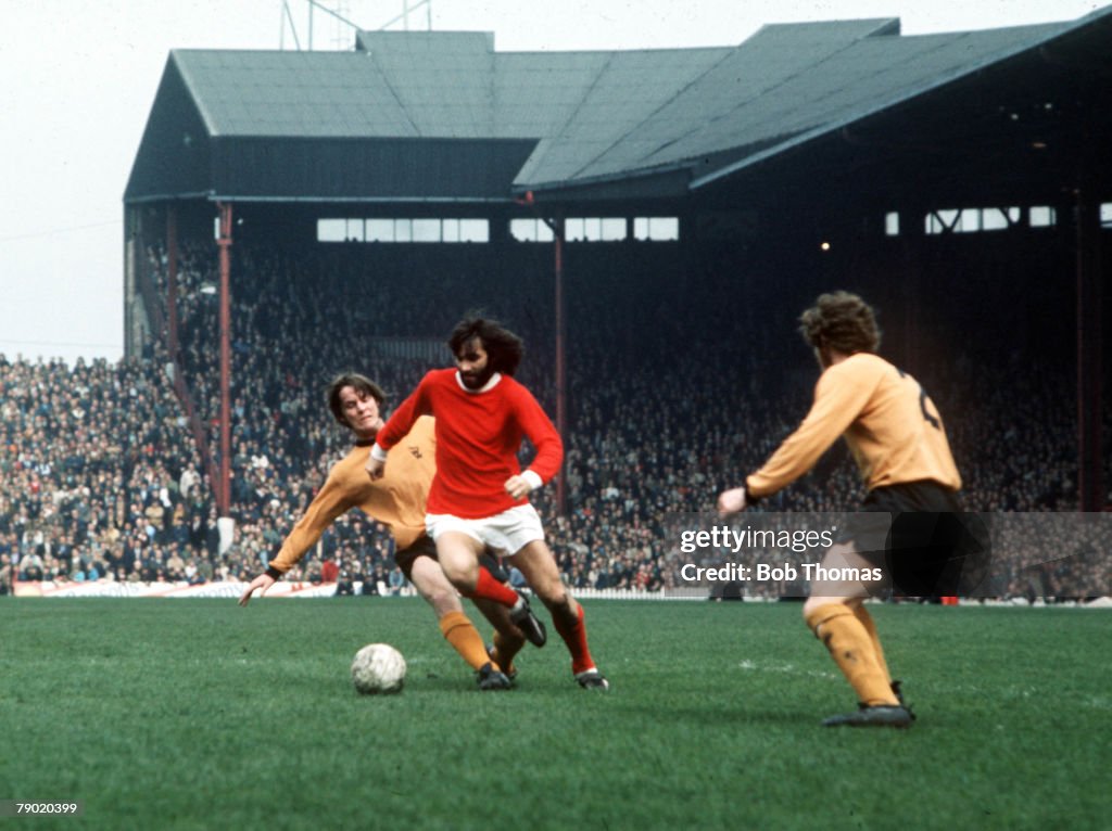 Football. Manchester United's George Best is tackled by Wolverhampton Wanderer's McCalliog from behind during their league match at Old Trafford, 1971.