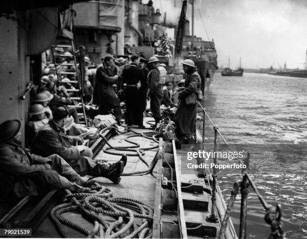 Troops from the British Expeditionary Force rest aboard a Royal Navy ship as it returns to an English harbour following the successful evacuation of...