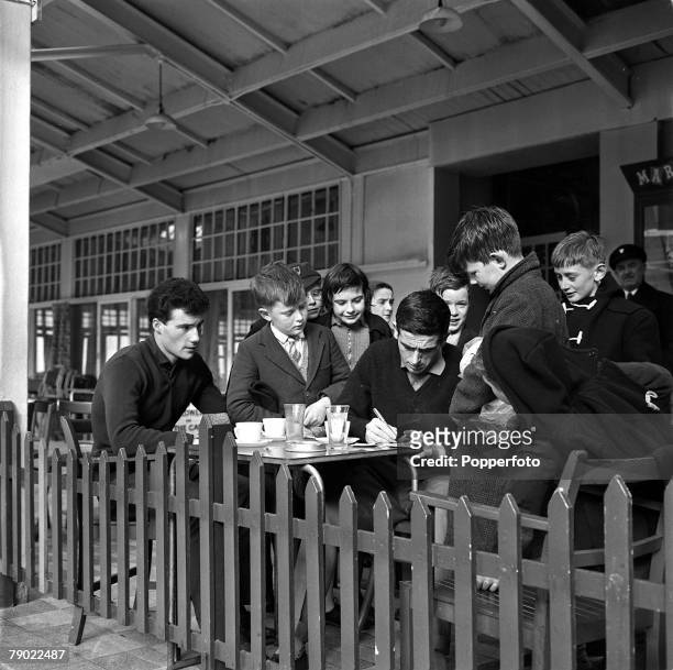 Football, 20th February 1962, Norbreck Hydro, England, Shay Brennan, United+s new penalty taker, signs autographs for young swimmers at the side of...