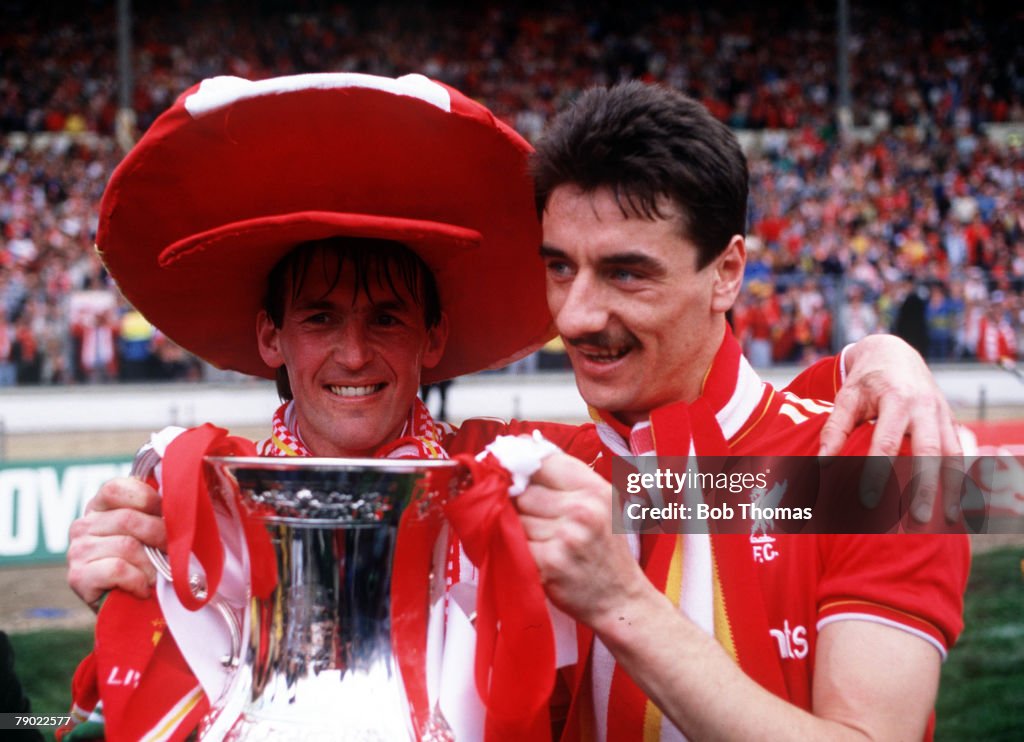 Football. 1986 FA Cup Final. Wembley. 10th May, 1986. Liverpool 3 v Everton 1. Liverpool player manager Kenny Dalglish and striker Ian Rush celebrate with the FA Cup trophy.
