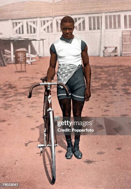 Portrait of American cyclist and World Champion Major Taylor as he poses with his bicycle, 1899. Taylor was the first African-American to become an...