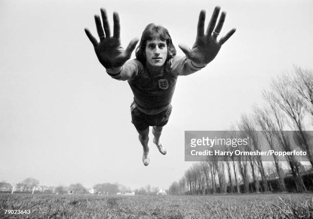 Liverpool FC goalkeeper Ray Clemence diving towards the camera, circa 1974.
