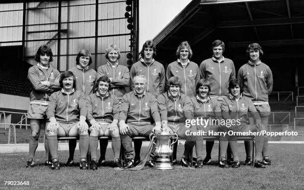 Liverpool FC line up for a team photograph alongside the FA Cup trophy at Anfield in Liverpool, England, circa August 1974. Back row : Kevin Keegan,...