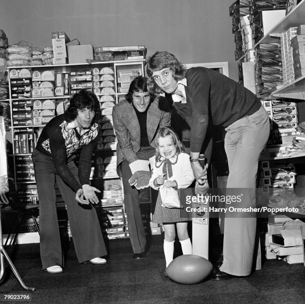 Everton footballer Jim Pearson practicing his forward defensive shot with a cricket bat, as Liverpool footballers Ray Clemence and Kevin Keegan...
