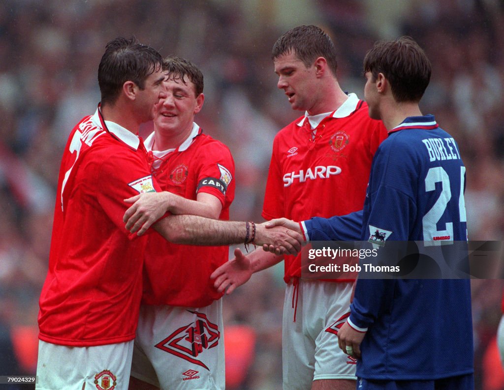 Football. 1994 FA Cup Final. Wembley. 14th May, 1994. Manchester United 4 v Chelsea 0. Chelsea's Craig Burley congratulates victorious Manchester United players L-R: Eric Cantona, Steve Bruce and Gary Pallister after the match.