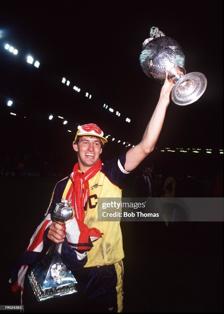 Sport. Football. Anfield, England. League Division One. 26th May 1989. Liverpool 0 v Arsenal 2. Arsenal captain Tony Adams celebrates with the League Championship trophy and the Barclays trophy at the end of the match.