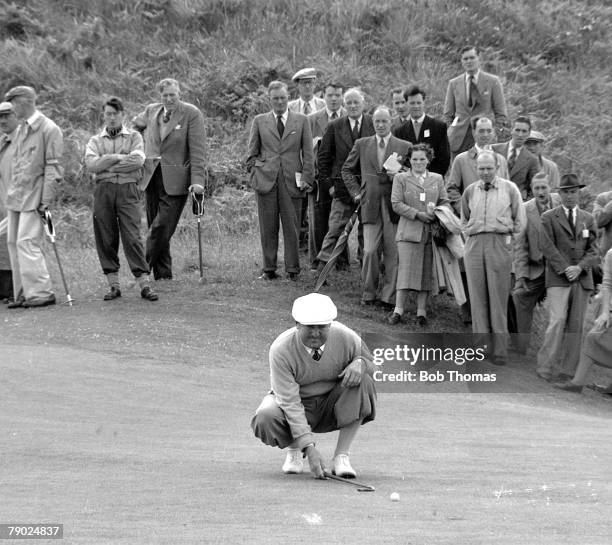 South African professional golfer Bobby Locke lines up a putt on the green during play to finish in joint 6th place in the 1951 Open Championship at...