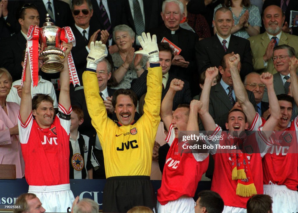 Football. 1998 FA Cup Final. Wembley. 16th May, 1998. Arsenal 2 v Newcastle United 0. Arsenal captain Tony Adams proudly holds aloft the trophy as he celebrates with goalkeeper David Seaman, Lee Dixon, Nigel Winterburn and Martin Keown.