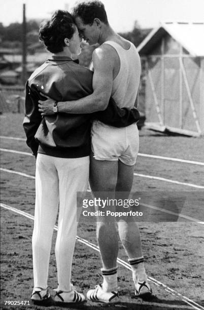 British athlete Robbie Brightwell with his fiancee, English sprinter and hurdler Ann Packer during training ahead of competition in the 1964 Summer...