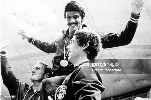 Mark Spitz celebrates with teammates after he won his seventh swimming gold medal with the United States team winning the Men's 4 x 100 medley relay...