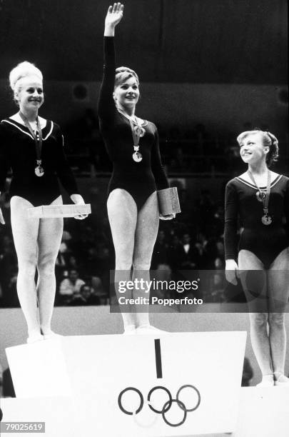 From left, joint gold medal winners Vera Caslavska of Czechoslovakia and Larisa Petrik of the Soviet Union stand on the medal podium along with...