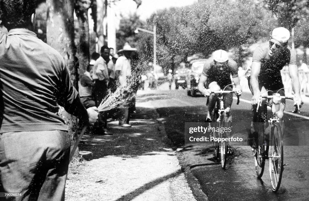 1960 Olympic Games. Rome, Italy. Cycling. Road Race. Dutch riders Hugens and Van Krennigen get a drink from a hosepipe.