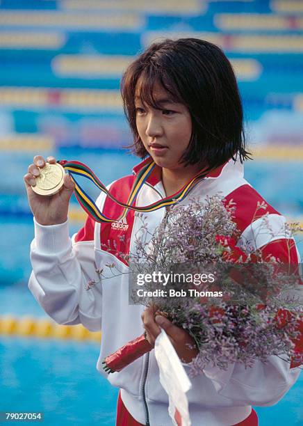 Japanese swimmer Kyoko Iwasaki displays her gold medal on the podium after finishing in first place to win the gold medal in the final of the Women's...