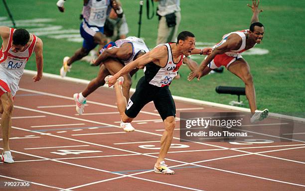 Canadian track and field athlete Mark McKoy crosses the finish line in first place to win the gold medal in the Men's 110 metres hurdles event at the...