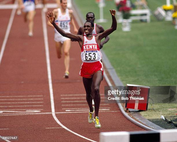 Kenyan athlete Julius Kariuki celebrates as he crosses the finish line in first place to win the gold medal in the Men's 3000 metres steeplechase...