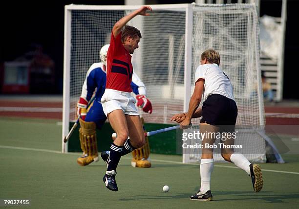 English field hockey player Richard Lerman of the Great Britain team battles for the ball with German field hockey player Carsten Fischer during his...