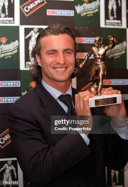 London, 25th May Tottenham Hotspur player David Ginola holds his Football Writers Player of the Year trophy