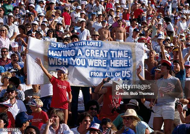 American athletics fans display a banner with the message 'To Russia With Love! Having a Great Time, Wish You Were Here', in reference to the boycott...