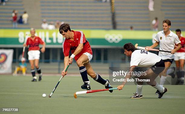 English field hockey player Sean Kerly of the Great Britain team pictured in action racing away with the ball during his side's gold medal 3 - 1 win...