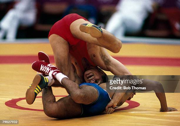 Mieczyslaw Tracz of Poland wrestles with Brahim Loksairi of Morocco in their round 2 Group A match in the Men's Greco-Roman 62kg event at the 1988...