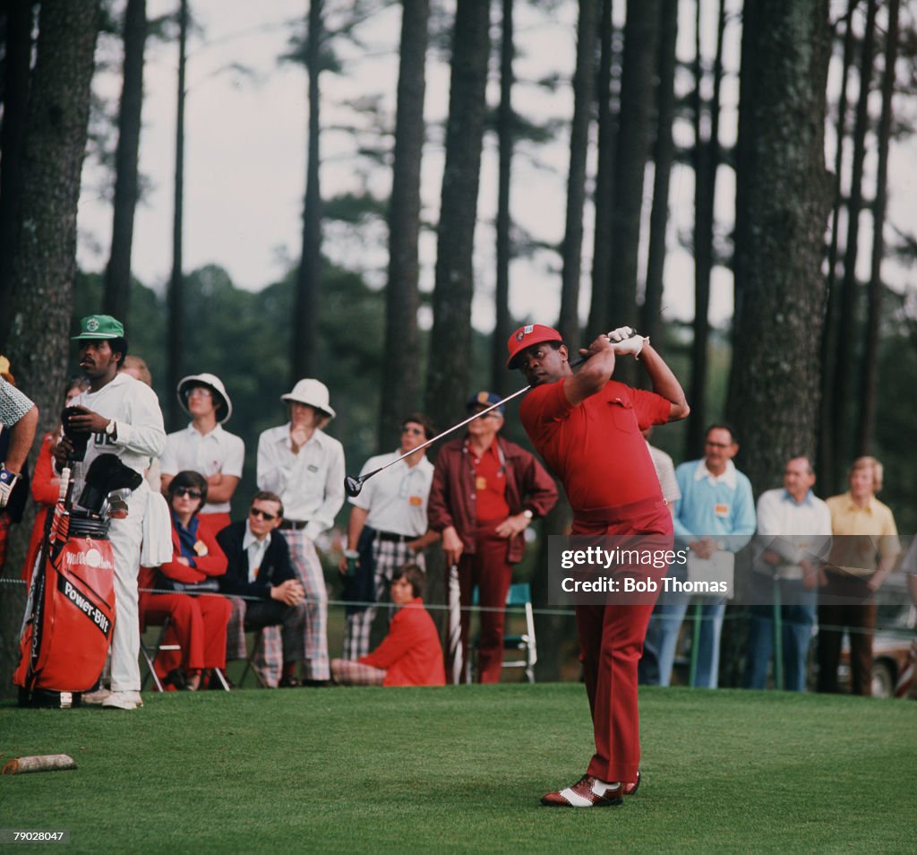 Golf. 1977 U.S Masters. Augusta, Georgia. Lee Elder driving against a backdrop of trees.
