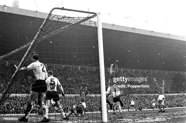 Scottish footballer Denis Law celebrates after scoring Manchester United’s third goal against Burnley in a League Division One match at Old Trafford,...