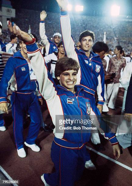 American gymnast Mary Lou Retton pictured front with fellow United States team members as they parade around the athletics track inside the Memorial...